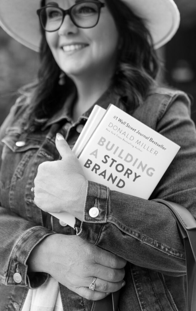 Shannon holding a StoryBrand book